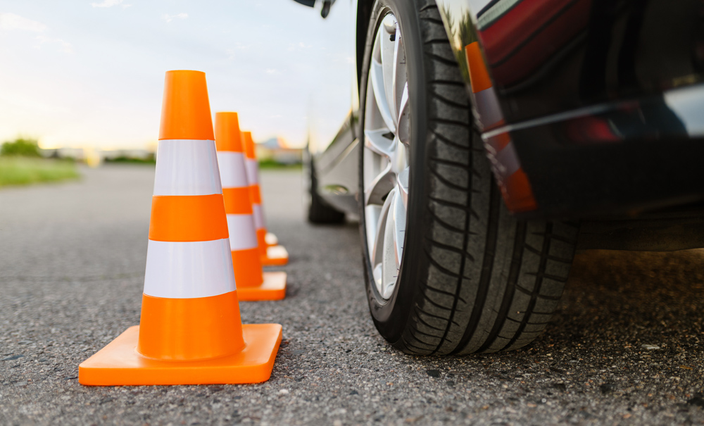 Car and traffic cones, driving school concept