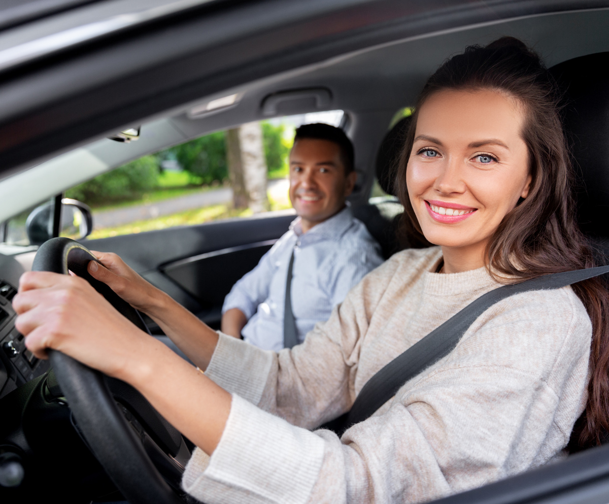 car driving school instructor teaching woman