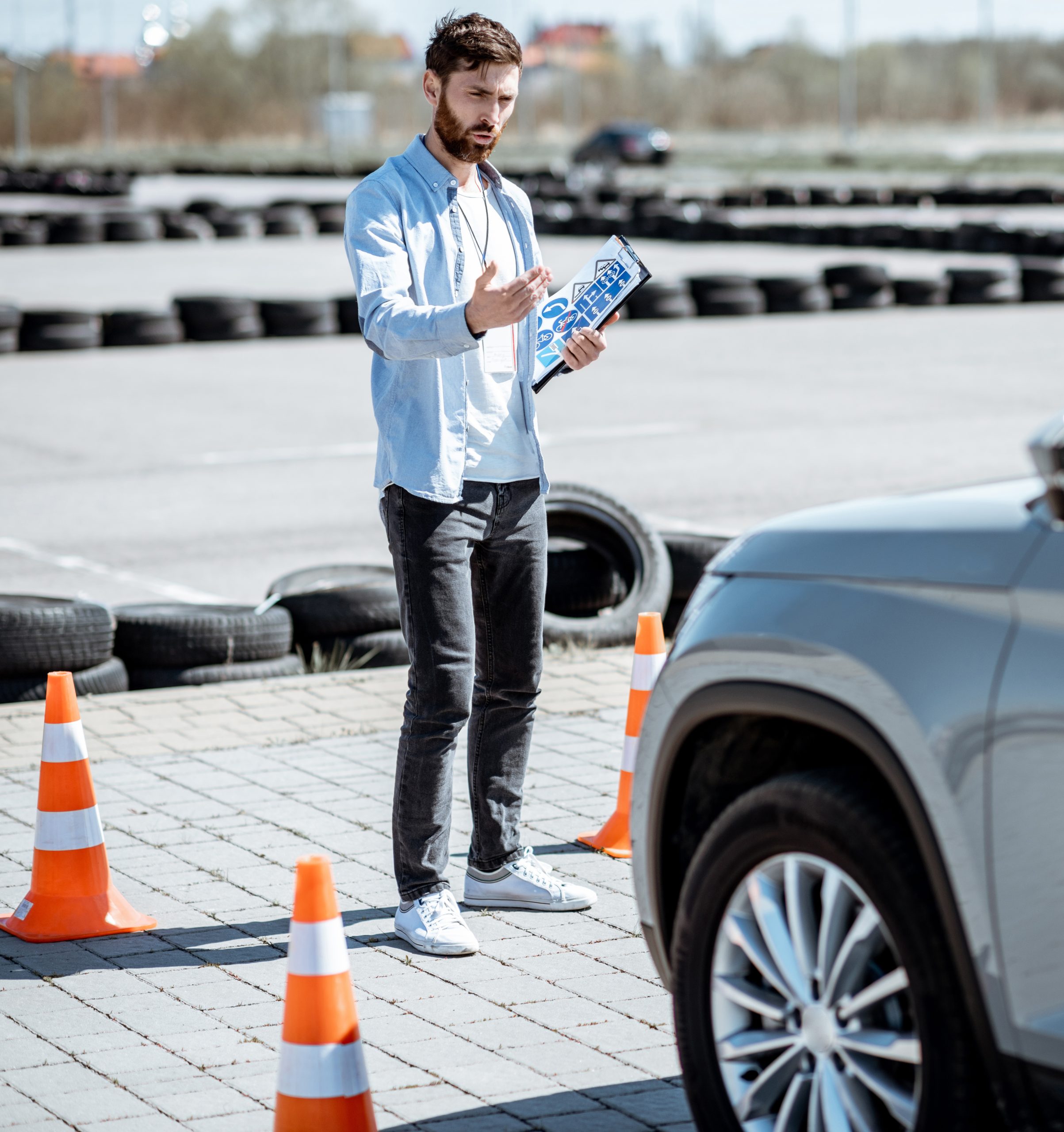 Instructor teaching to drive a car on the training ground
